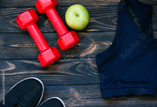 sports top, red dumbbells, green apple, sports shoes