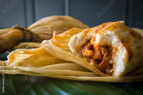 Chuchitos (Guatemalan Tamales) Filled with Pork and Wrapped in Corn Husk photo