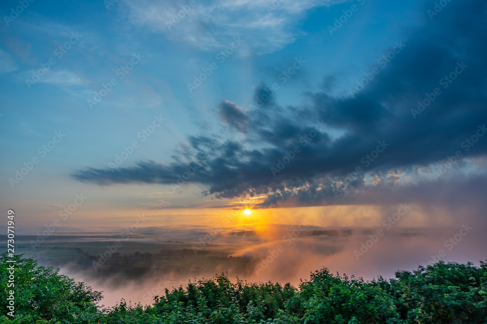 Sunrise on a foggy summer morning over the village Sunrise on a foggy summer morning over the village