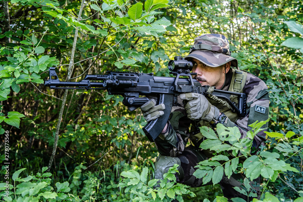 Army soldiers special forces in the wood forest aiming machine gun airsoft game war battle mission campaign Army soldiers special forces in the wood forest aiming machine gun airsoft game war battle mission campaign