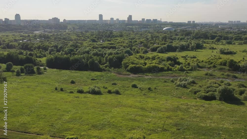 Air view of the metropolis on a summer day from the floodplain of the river and green areas Air view of the metropolis on a summer day from the floodplain of the river and green areas