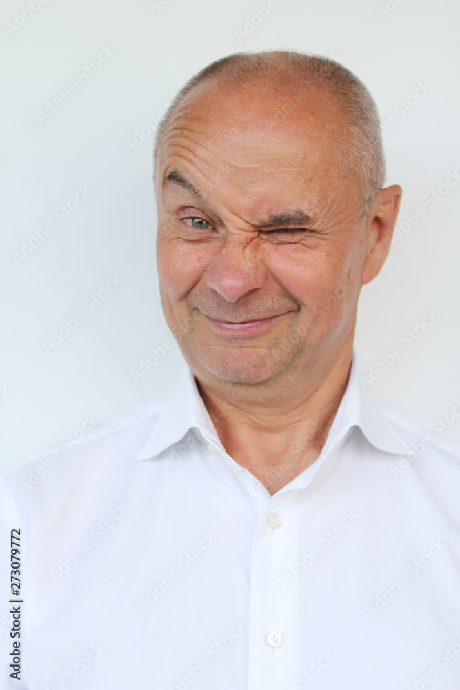 bald old man in a white shirt showing grimaces, winks, smiling, close-up bald old man in a white shirt showing grimaces, winks, smiling, close-up