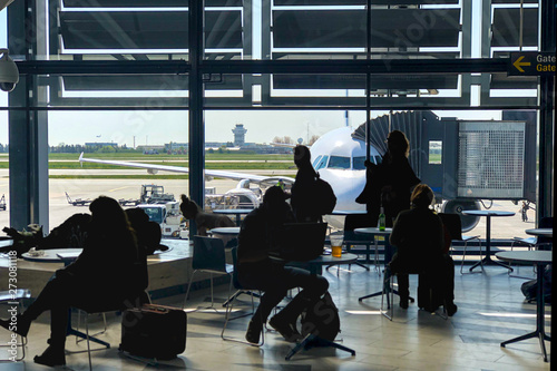 Canvas Print Passengers killing time in airport terminal, waiting to be boarded on to the pla