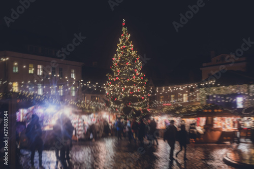 View of Tallinn Old Town, traditional european Christmas Fair Market at Old Town Hall Square, with Christmas tree and fair kiosk with loads of shining decoration, Estonia