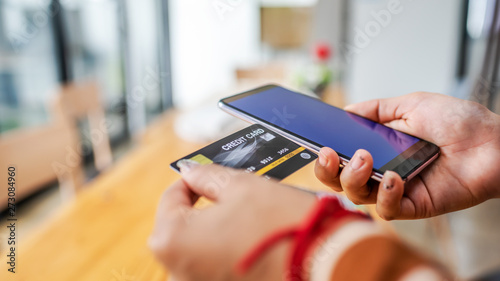 Close up young woman hands holding credit card.