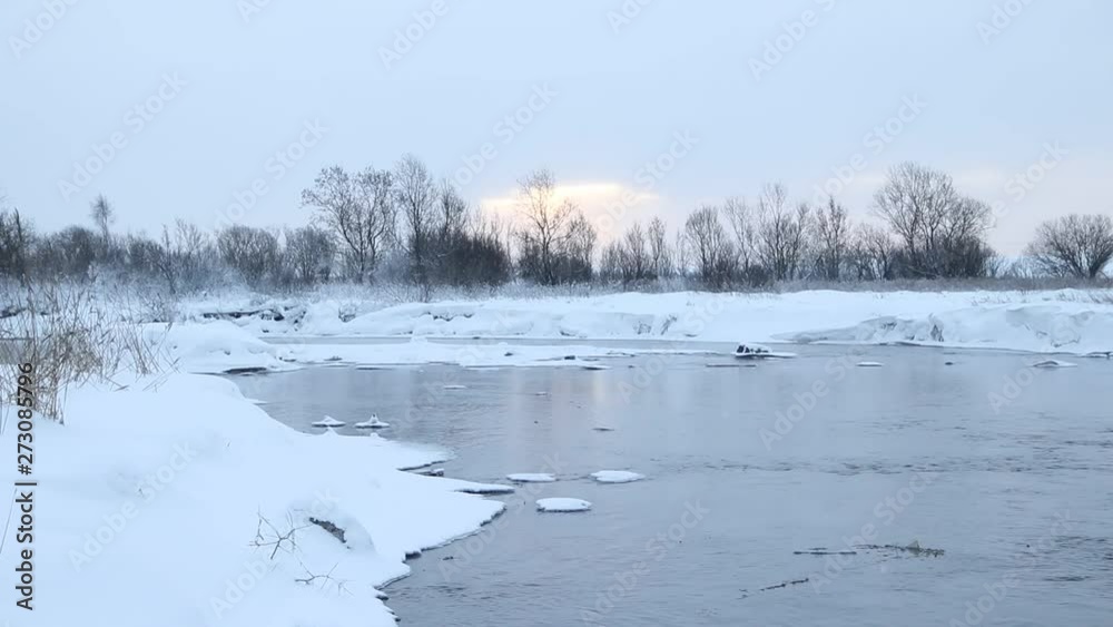 River in winter with snow. The river at dawn. Evaporation from water. Frosty winter. The water did not freeze in winter. River in winter with snow. The river at dawn. Evaporation from water. Frosty winter. The water did not freeze in winter.