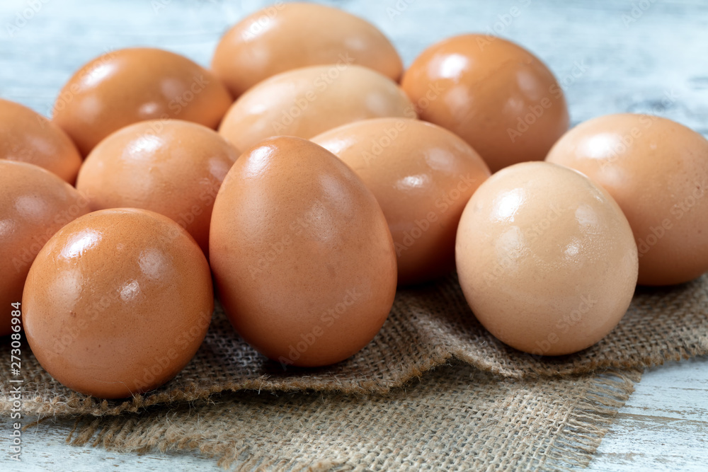 Raw organic brown farm raised eggs on burlap cloth Raw organic brown farm raised eggs on burlap cloth