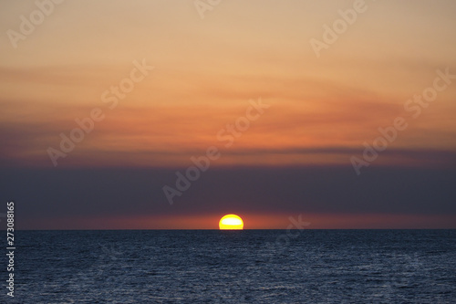 Fototapeta Naklejka Na Ścianę i Meble -  The setting sun under a blanket of wildfire smoke over the Gulf of Mexico off East Cape Sable in Everglades National Park, Florida.