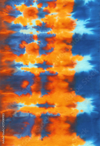 Hand painted abstract spotted colorful tie-dye shibori textile background pattern in orange and blue photo