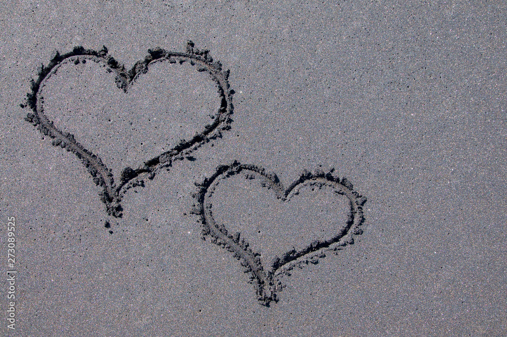 Heart shapes on black sand beach
