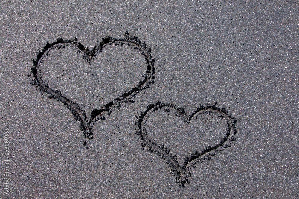 Heart shapes on black sand beach