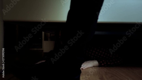 The girl hiding under the bed from a pursuer, a robber, a rapist, a criminal of an evil husband or father. Domestic violence concept.