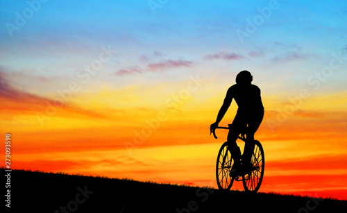Fototapeta Naklejka Na Ścianę i Meble -  Silhouette man  and bike relaxing on blurry sunrise  sky   background.