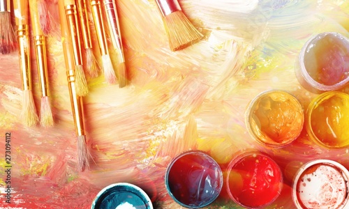 Composition of dirty painting brushes on colorful background