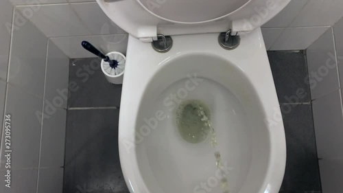 peeing in a toilet bowl from a standing point of view photo