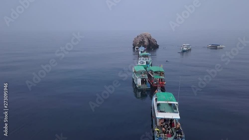 4K aerial zooming into best dive spot in Chumphon pinnacles, Sail Rock in Koh Tao, Thailand photo