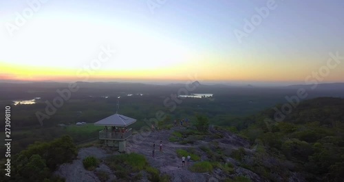 Aerial shot of Australia's landscape, mount Tinbeerwah lookout at sunset with people and amazing view. Lakes, forests, mountains in the background. Sunshine Coast, Queensland. photo