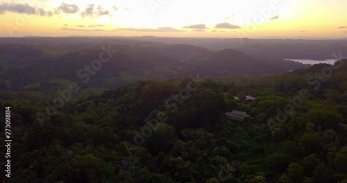 Aerial view of hills in a tropical forest valley at sunset - Kondalilla, Australia. Golden sky with clouds. photo