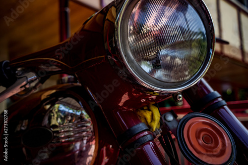 A fragment of a classic motorcycle, headlight and gas tank. © Sergey Potapov