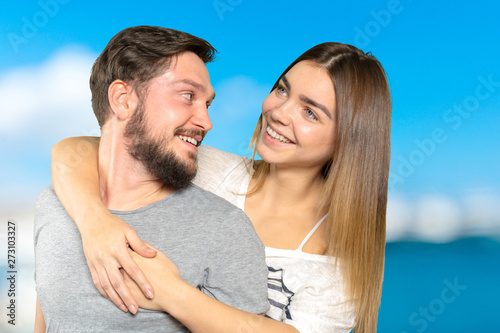 Happy couple embracing and looking at camera