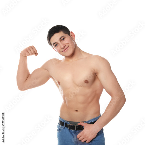 Portrait of shirtless muscular man showing bicep on white background
