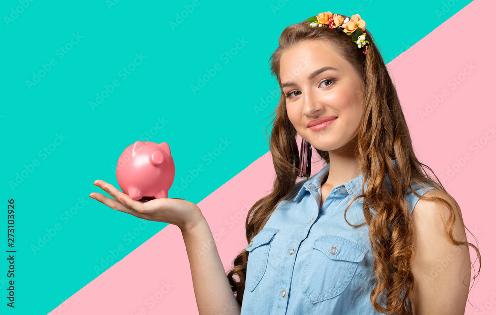 Beautiful young woman with piggy bank isolated Beautiful young woman with piggy bank isolated