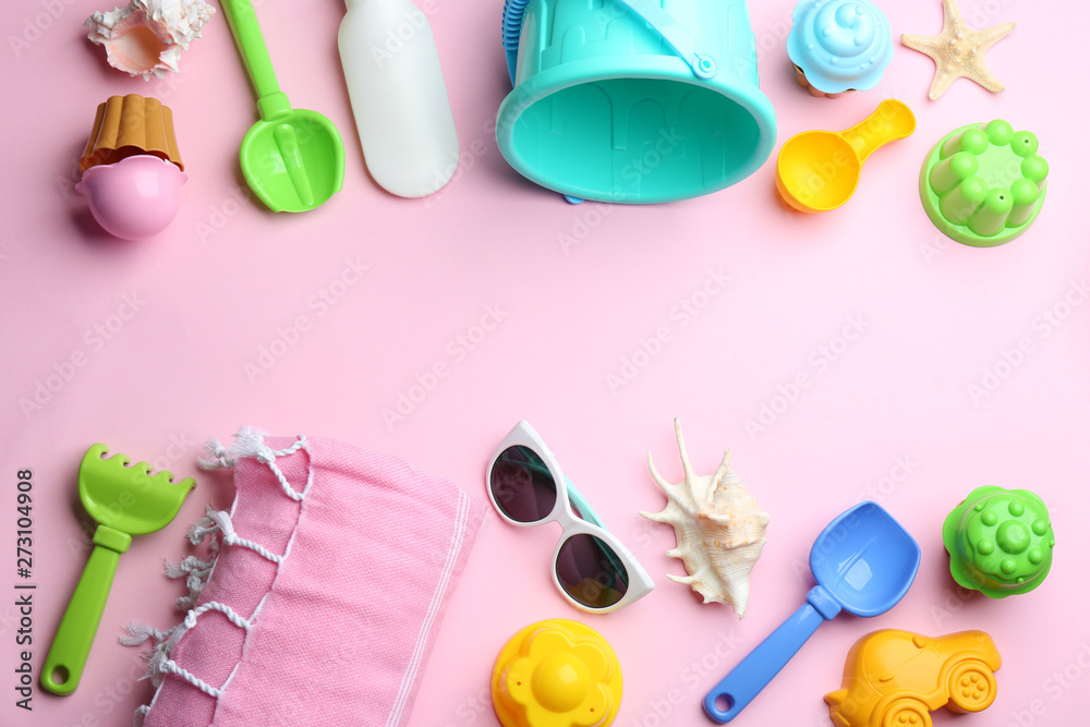 Flat lay composition with bright beach toys on color background. Space for text