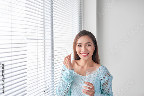 Free Download Omega 3. Fat fish. Beautiful girl takes fish oil. Woman takes omega 3. Healthy food. Vitamin D, E, fish oil capsules. - GFXLoad