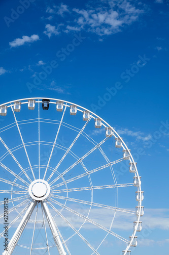 Picture of a Ferris wheel against the blue sky.