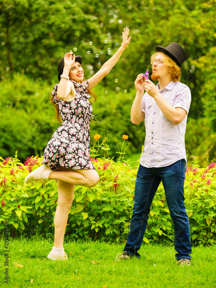Obraz premium Couple blowing bubbles outdoor