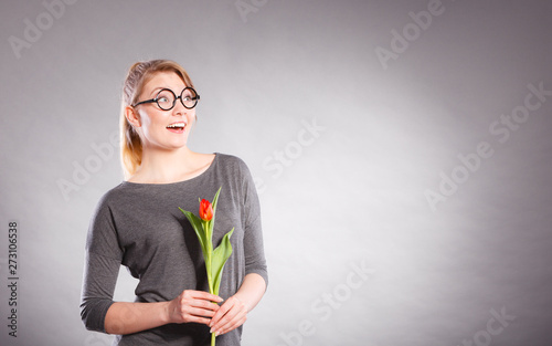Fototapeta Naklejka Na Ścianę i Meble -  Happy blonde woman with spring flower.
