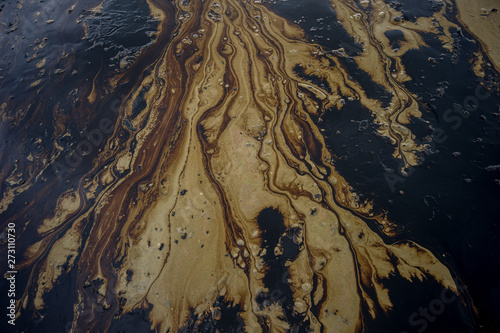 Oil sludge contaminating the sea during the oil spill disaster in Samet Island, Rayong, Thailand.