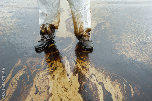 Petroleum spill mixed with other chemical substances on sea and sand surface. Pollution images, Samet Island, Thailand.