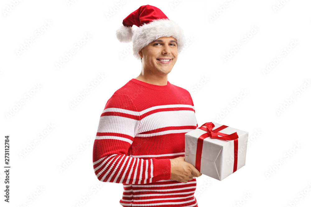Young man wearing a santa claus hat and holding a christmas gift box