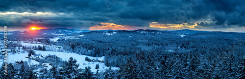 Sunset with dramatic sky over the winter landscape near Neuschönau in the Bavarian Forest National Park in Bavaria, Germany. © DirkR