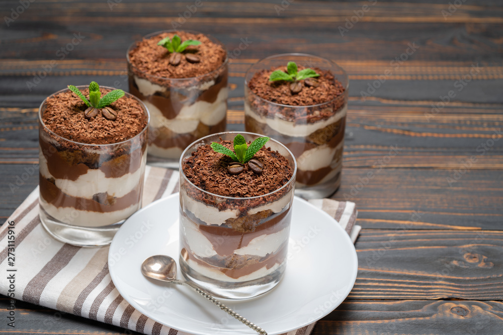 Classic tiramisu dessert in a glass on wooden background Classic tiramisu dessert in a glass on wooden background