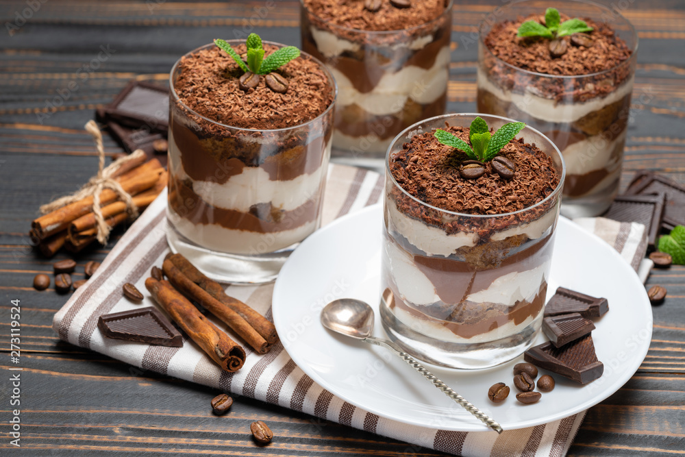 Classic tiramisu dessert in a glass on wooden background Classic tiramisu dessert in a glass on wooden background