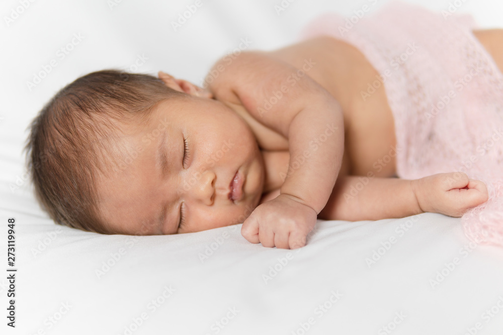 Adorable asian newborn baby in pink wrap sleeping on white blanket background. Adorable asian newborn baby in pink wrap sleeping on white blanket background.