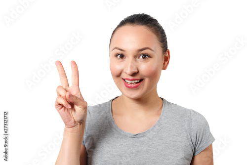 Beautiful young happy smiling girl showing victopy sing with her hand. Peace concept. Sign of gestures. isolated on white. It is ok