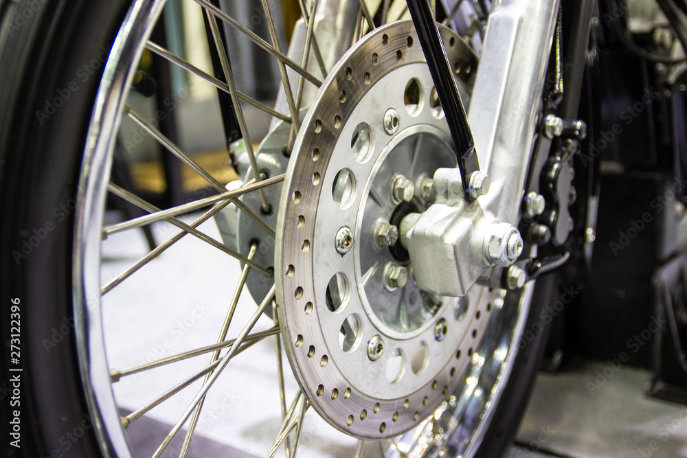 close up - wheel spokes and brake disc of a motorcycle concept new design techonology close up - wheel spokes and brake disc of a motorcycle concept new design techonology