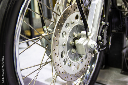 close up - wheel spokes and brake disc of a motorcycle concept new design techonology
