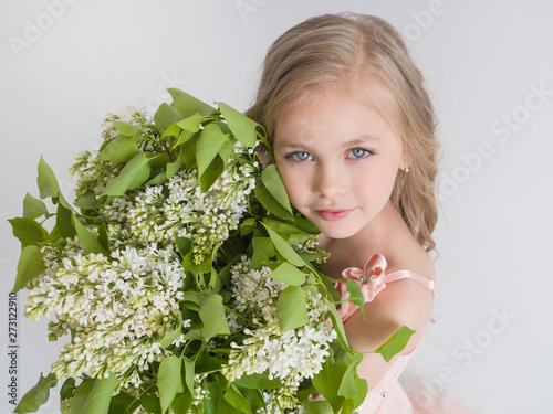 Beautiful girl with a lilac in the hands of