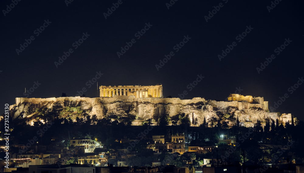 Ancient Acropolis of Athens view by night from Monastiraki Square - night-scape or cityscape with illuminated hill - negative space - body copy.