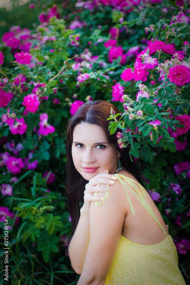 portrait of a young girl in pink rose hips