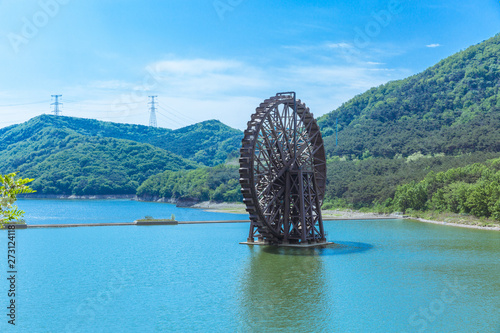 Large wooden waterwheel and blue water, Xijiao National Forest Park, Dalian, China