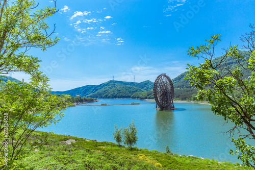 Large wooden waterwheel and blue water, Xijiao National Forest Park, Dalian, China