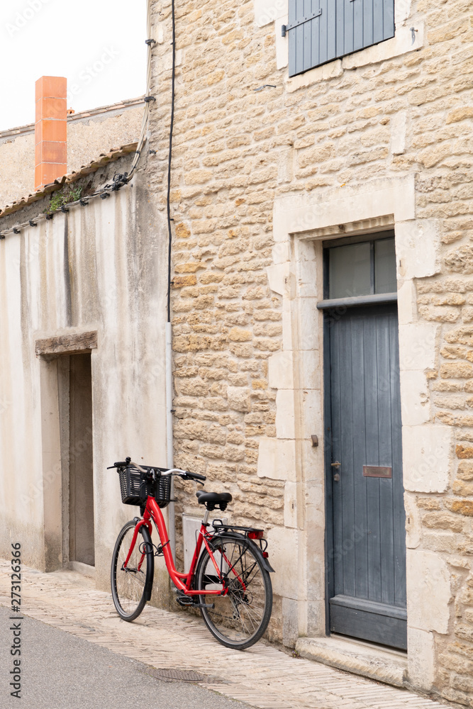 Isle of Re old stone house with grey shutters and bike in France