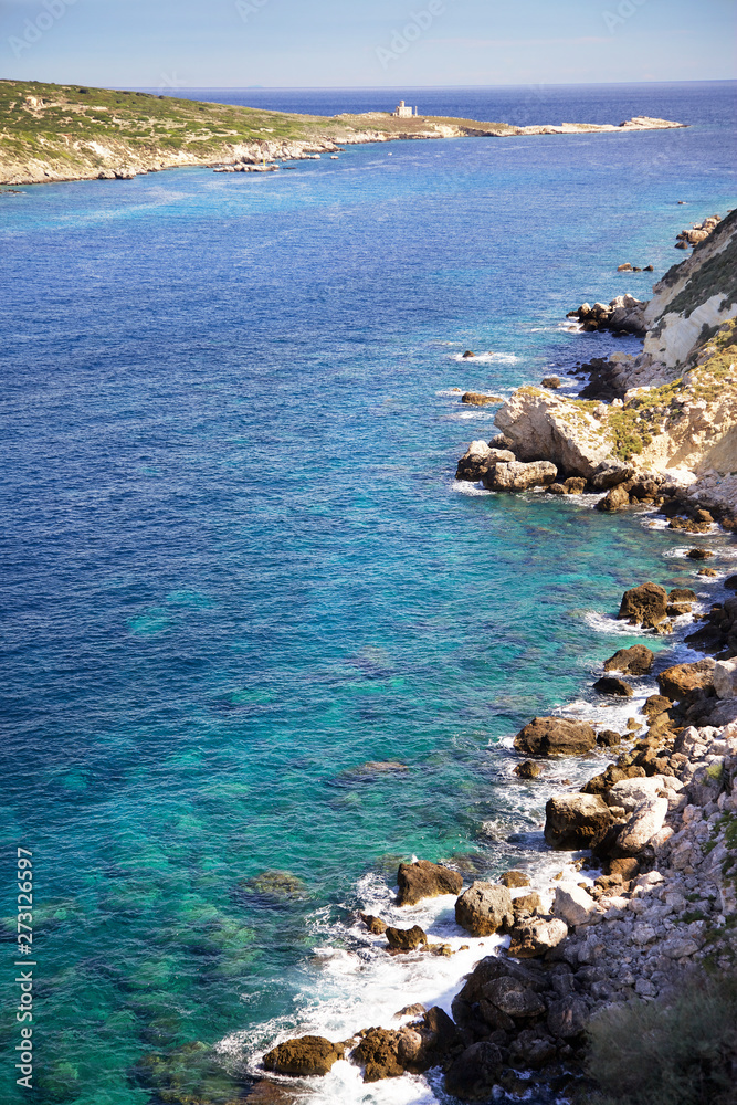Panoramic view of the rocks, the sea and the island of Capraia and lighthouse.