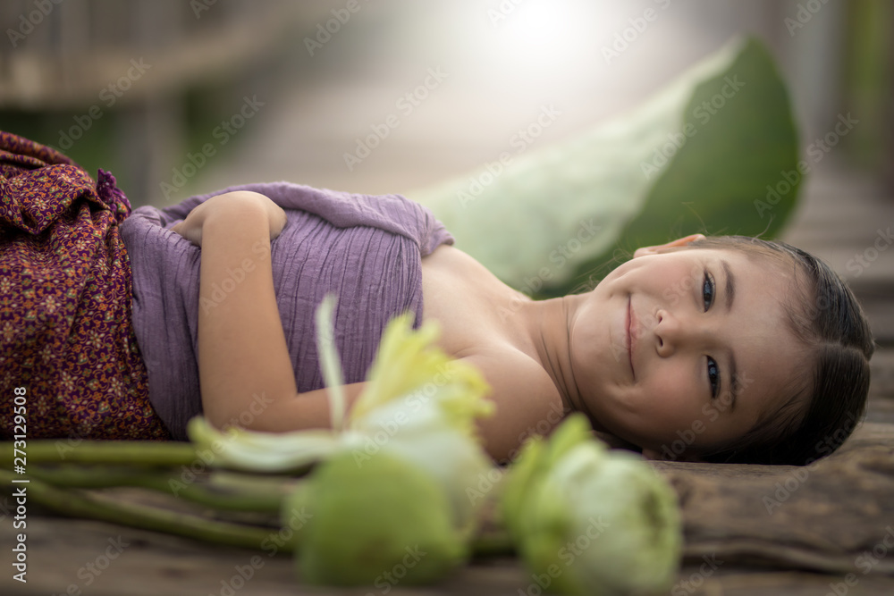 Obraz premium foreigner girl in Thai costume posing in the nature with happy.