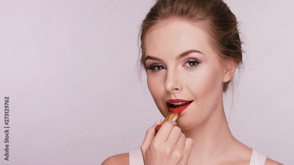 pretty girl applies red lipstick and showing kisses pretty girl applies red lipstick and showing kisses